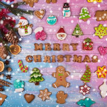 Different ginger cookies for new years and christmas on wooden background, top view
