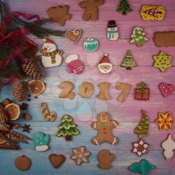 Different ginger cookies for new 2017 year holiday on wooden background, xmas theme. Toned photo.