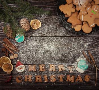 Different ginger cookies for new years and christmas on wooden background, top view
