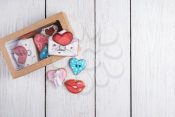 Gingerbreads for Valentines Day in gift box on white wooden background
