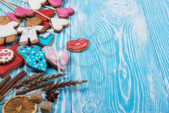 Gingerbreads for Valentines Day or wedding theme on blue wooden background