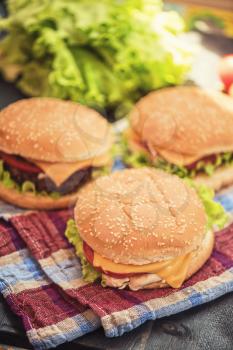 Closeup of home made burgers on wooden table