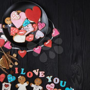 Gingerbreads for Valentines Day on dark concrete background