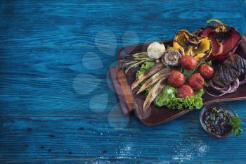 Grilled vegetable on a blue wooden background