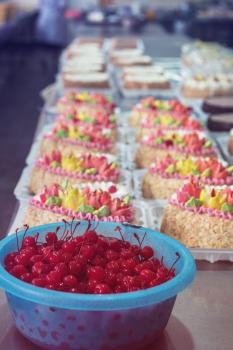 Bowl of cherry on cake production in factory