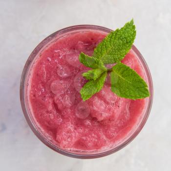 Strawberry smoothie with mint on a white concrete background. Square cropping