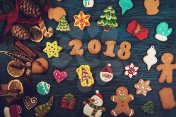 Gingerbreads for new 2018 year on wooden background, xmas theme