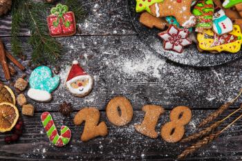 Gingerbreads for new 2018 year on wooden background, xmas theme