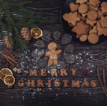 Homemade ginger cookies for new years and christmas on wooden background, xmas theme
