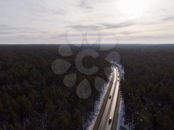Aerial view of a road with traffic in winter landscape