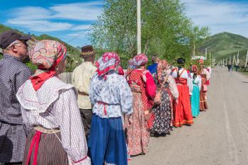 TOPOLNOE, ALTAY, RUSSIA - May 27, 2018: Folk festivities dedicated to the feast of the Holy Trinity. Ancient Russian rite: procession with a birch for its further sinking.