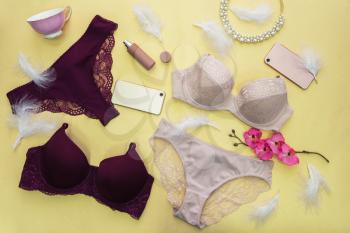 Set of modern female lingerie on yellow backgound, flat lay