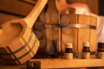 Wooden bath accessories with aromatic oil bottle for bath in the sauna