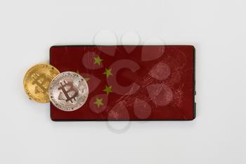 Bitcoin coin on phone with china flag