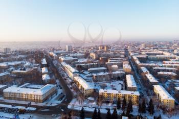 Aerial view of the colorful frosty winter evening and residential areas in Barnaul.