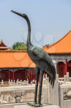 Bronze crane with raised head on the marble terrace of the Hall of Supreme Harmony in the Forbidden City in Beijing