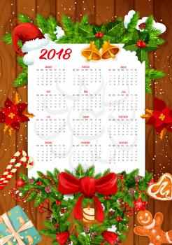 Christmas holiday calendar on wooden background. New Year and winter holidays calendar template with Xmas tree and holly wreath, gift, bell and ribbon, candy, snowflake, candle and cookie