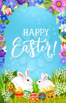 Easter religious holiday bunnies with eggs in green grass vector greeting poster, decorated with spring flower frame. White rabbits and painted eggs with floral wreath of tulips, lilies and daffodils