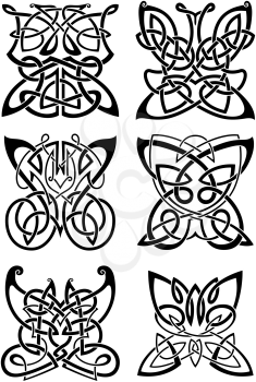 Celtic tattoos of graceful black butterflies with ornamental wings, composed from traditional scandinavian knot patterns. Isolated background