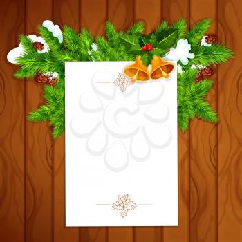 Christmas and New Year greeting card with blank paper, decorated by holly berry with bell and snowy pine branch with cone on wooden background. Xmas card template design with copy space