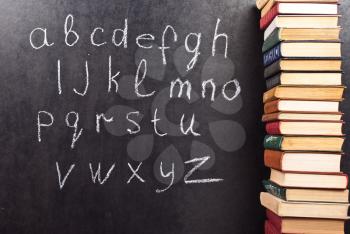 Royalty Free Photo of the Alphabet on a Chalkboard With Books