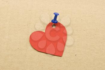 Royalty Free Photo of a Heart Tag on Cardboard