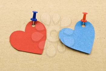 Royalty Free Photo of Heart Tags on Cardboard