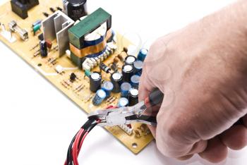 Royalty Free Photo of a Person Repairing a Circuit Board