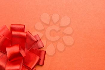 Royalty Free Photo of a Red Bow on Cardboard
