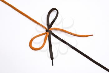 Royalty Free Photo of a Black and Red Shoelace With Bow