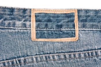 Royalty Free Photo of a Torn Label on Blue Jeans