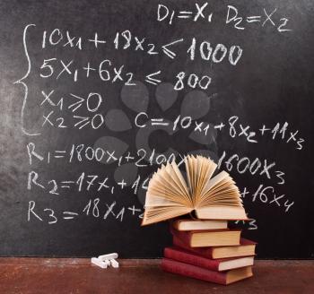 Royalty Free Photo of a Chalkboard and Textbooks