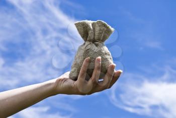 Royalty Free Photo of a Hand Holding a Bag of Money