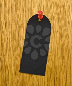 Royalty Free Photo of a Black Blank Tag on a Wooden Background