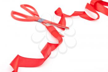 Royalty Free Photo of Scissors Cutting Red Ribbon