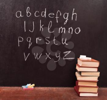 Royalty Free Photo of the Alphabet on a Chalkboard With Books