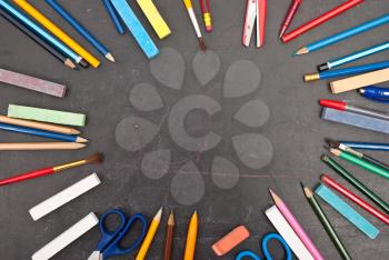 Chalkboard with school tools 
