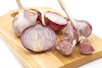 Garlic and onion on a wooden plate 