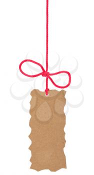 Royalty Free Photo of a Brown Rough Edged Tag Hanging From a Red String