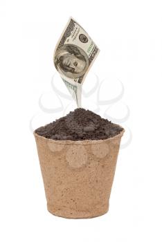 Royalty Free Photo of a Bucket of Soil With a 100 Dollar Bill on Top