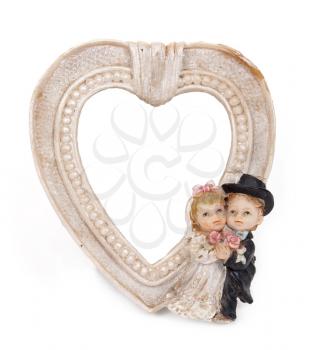 Royalty Free Photo of a Picture Frame  in the Shape of a Heart With Bride and Groom Icons