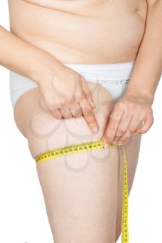 Fat woman measure her leg