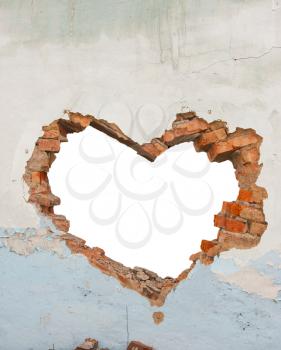 Heart shaped hole in old brick wall