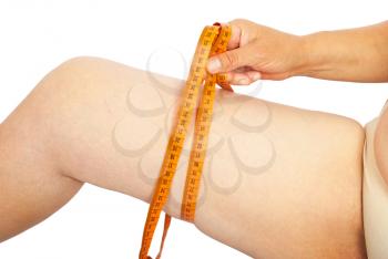 Fat woman measuring her thigh