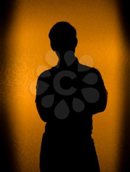 Studio shot - Back lit silhouette of man in the darkness