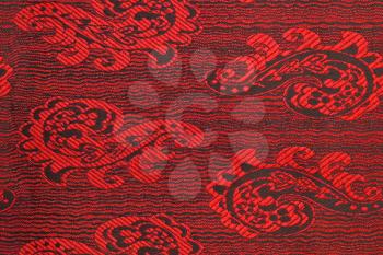 Beautiful fabric with red and black pattern. Useful as background 