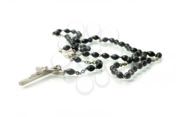 Black rosary isolated over white with focus on cross (shallow DOF)