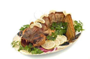 Bloated fresh-water catfish (sheatfish) with lemon and parsley on the plate