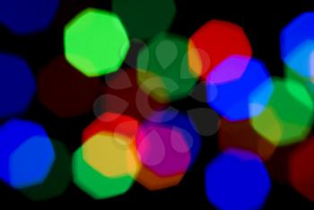 Blurred holiday colorful lights over black useful as background
