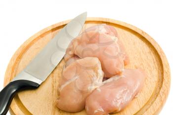 Chicken fillet and knife on hardboard isolated over white
